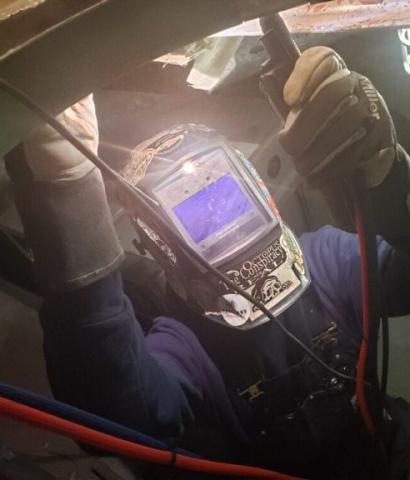 a person underwater wearing a military diving mask